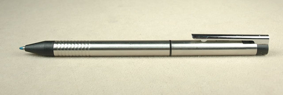 Silver ballpoint pen on beige background.