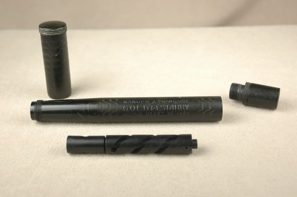 Disassembled pen with visible internal parts.