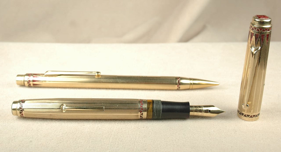 Gold fountain pen and ballpoint set.