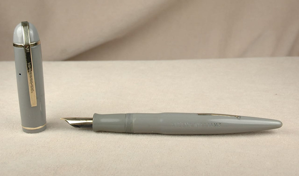 Gray fountain pen with detached cap.