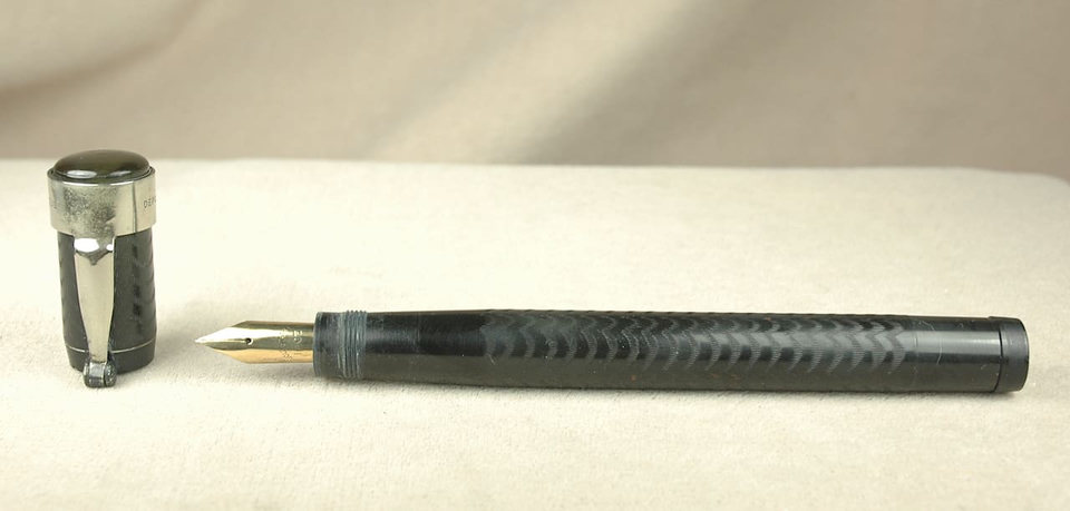 Black fountain pen with detached cap.