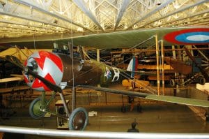 Vintage biplane displayed in museum hangar.