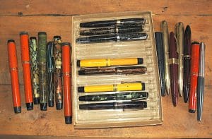 Collection of colorful vintage fountain pens displayed.