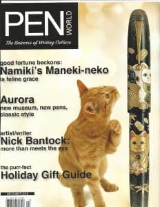 Magazine cover featuring cat and decorative pen.