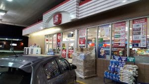 Convenience store exterior with parked car.