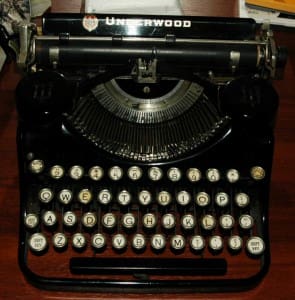 Vintage black Underwood typewriter on desk.