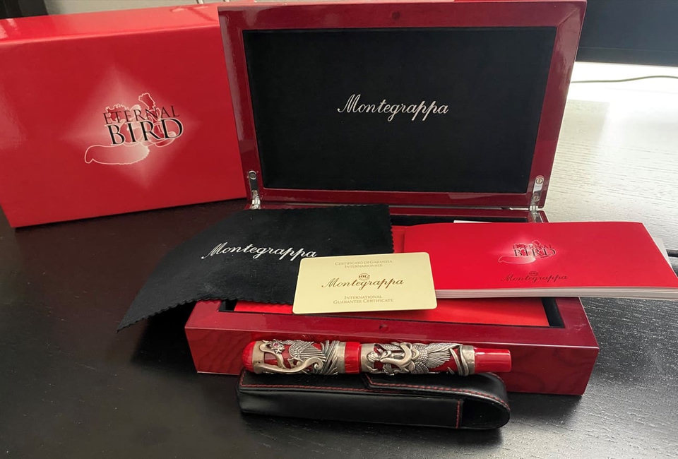 Red luxury pen set with ornate design.