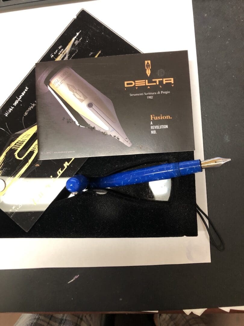 Blue fountain pen with Delta packaging.