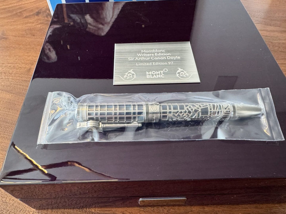 Montblanc pen in packaging on wooden box.