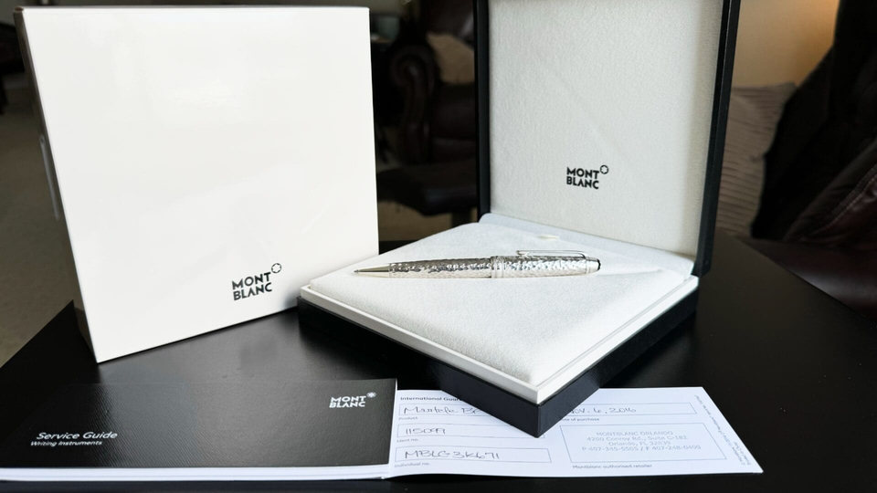 Montblanc pen in open box with documents.