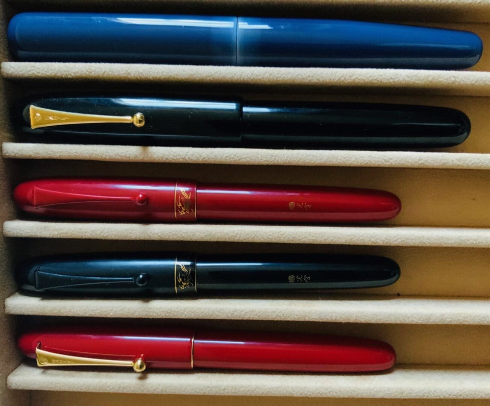 Four colorful fountain pens in a case.